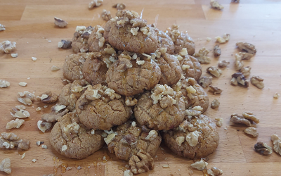 Melomakarona - traditional Greek Christmas honey cookies soaked in syrup and topped with walnuts.