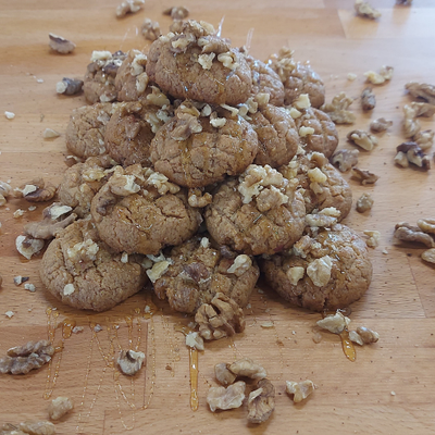 Melomakarona - traditional Greek Christmas honey cookies soaked in syrup and topped with walnuts.